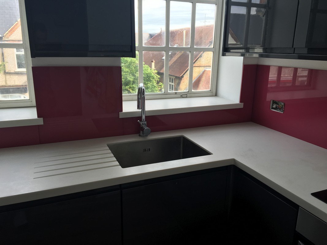 Deep plum coloured glass splashback in modern Cricklewood kitchen